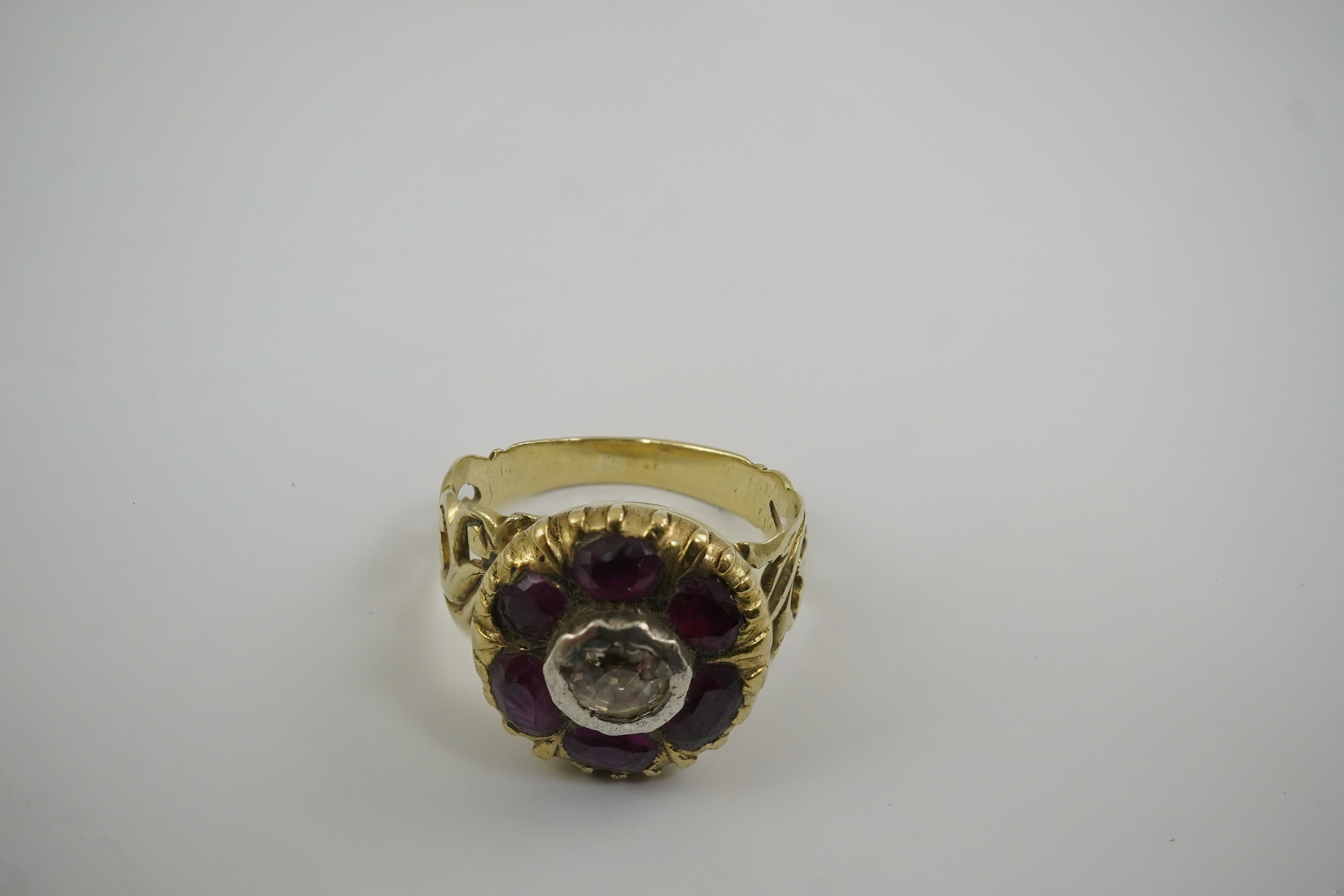 A Georgian gold, ruby and diamond circular cluster ring